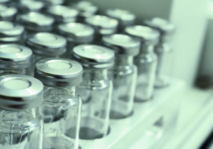 Pharmaceutical glass vials with stoppers used in stability testing to ensure packaging safety through sustainable analytical methods.