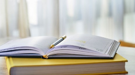 an open notebook with a pen
