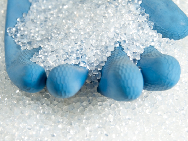 a hand with blue globe holding a bunch a salt