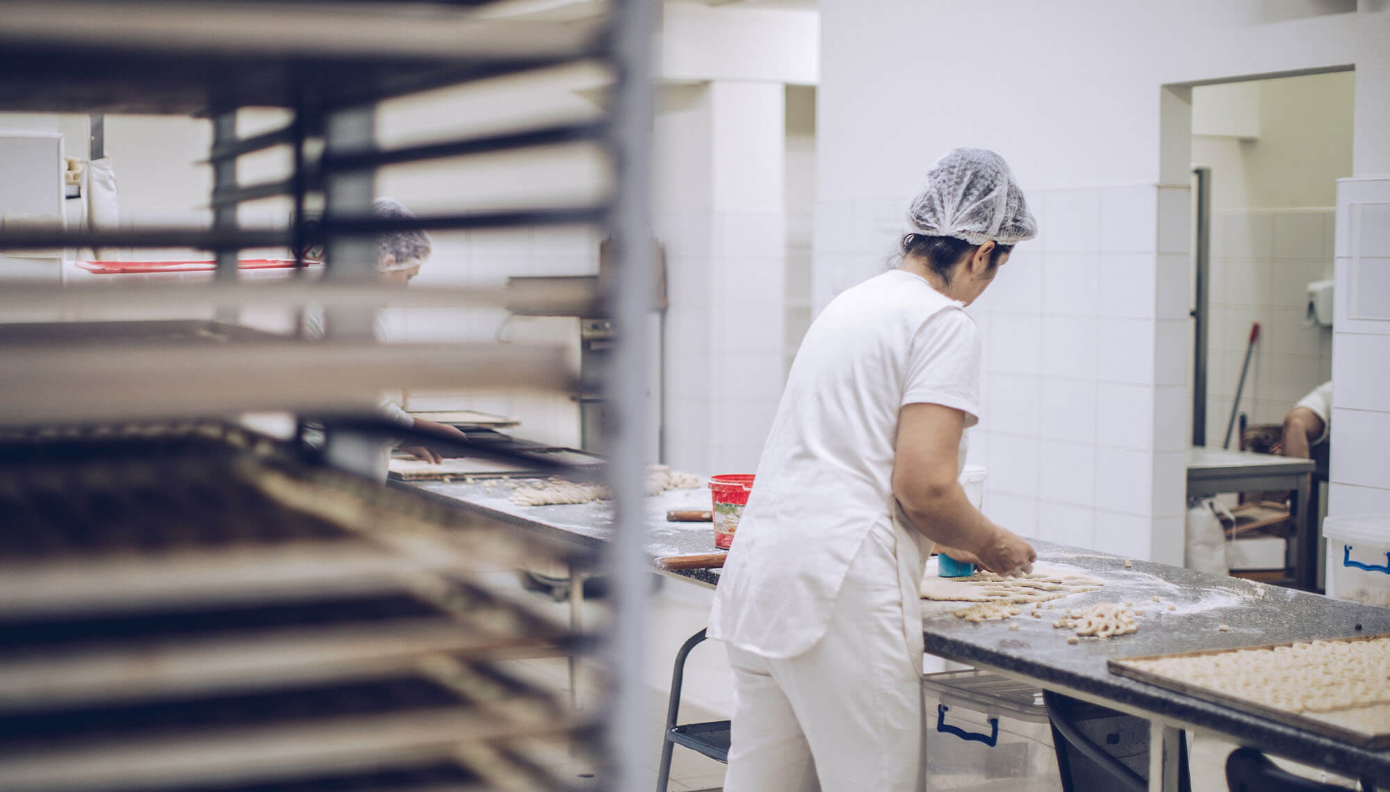 a woman working at a kitchen